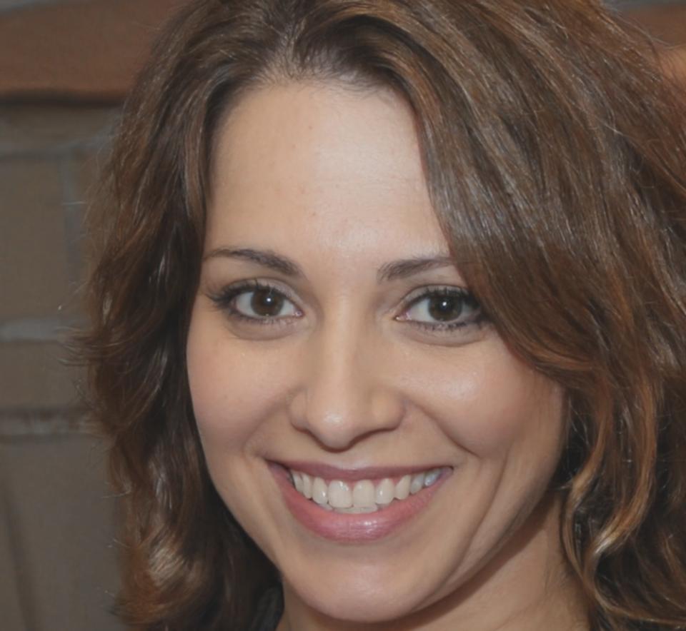 Portrait of Mirela Petrovic smiling in casual attire